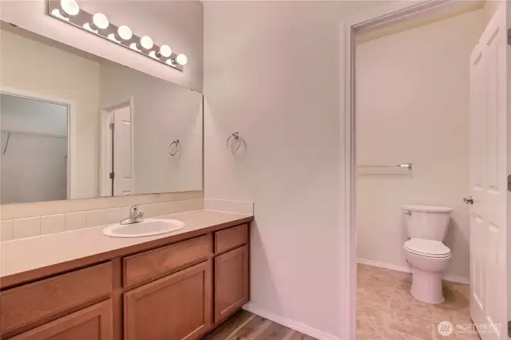 Primary bathroom with separate shower/toilet room.  A walk in closet is adjacent.