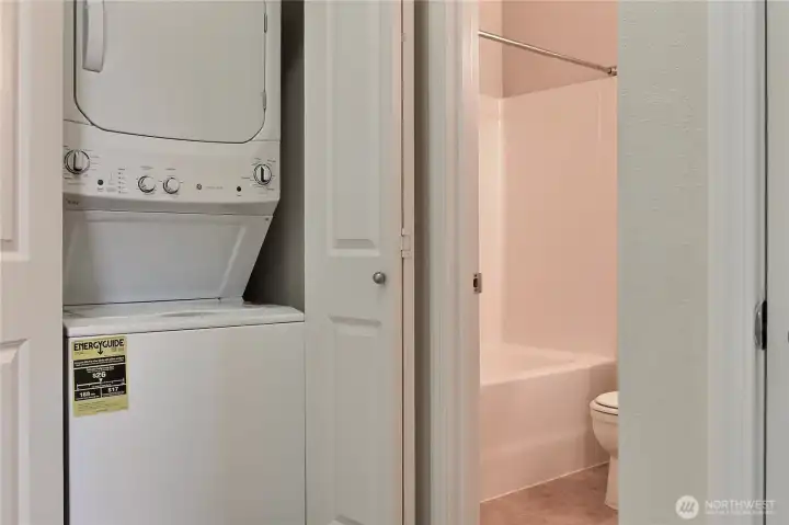 Stackable washer/dryer in hall closet.