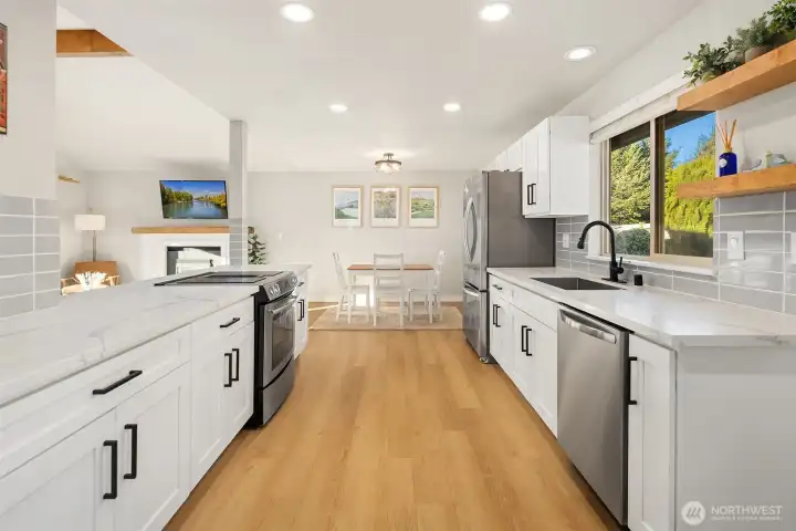 Spacious kitchen flowing seamlessly to dining area.