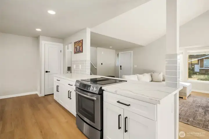 Kitchen with oversized island looking out to living area.