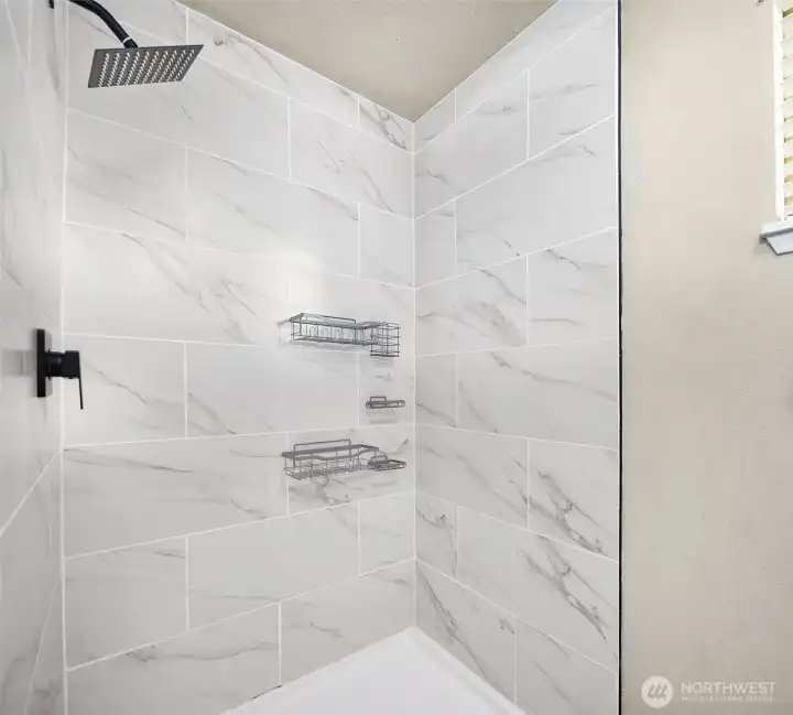 Ensuite with custom tile walk in shower.