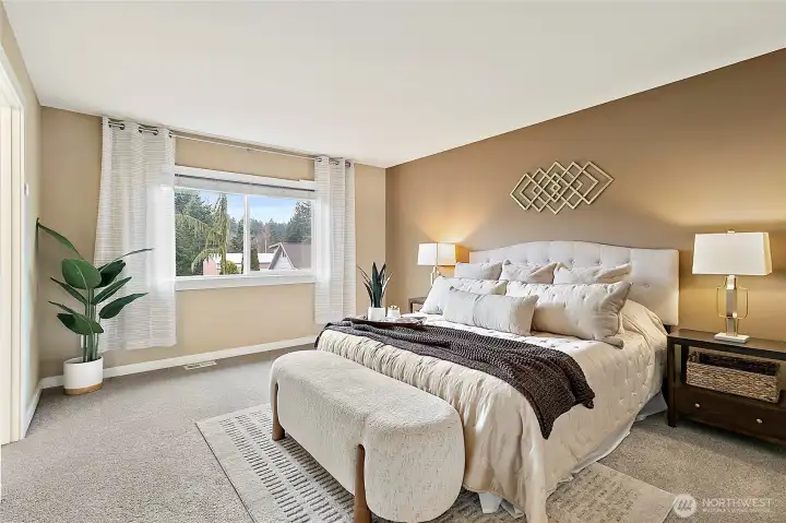 Spacious primary bedroom designed for relaxation.