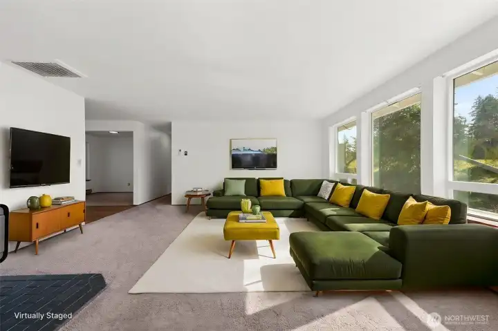 Large living area with a woodstove for cozy nights and three large windows allowing so much light into the area.