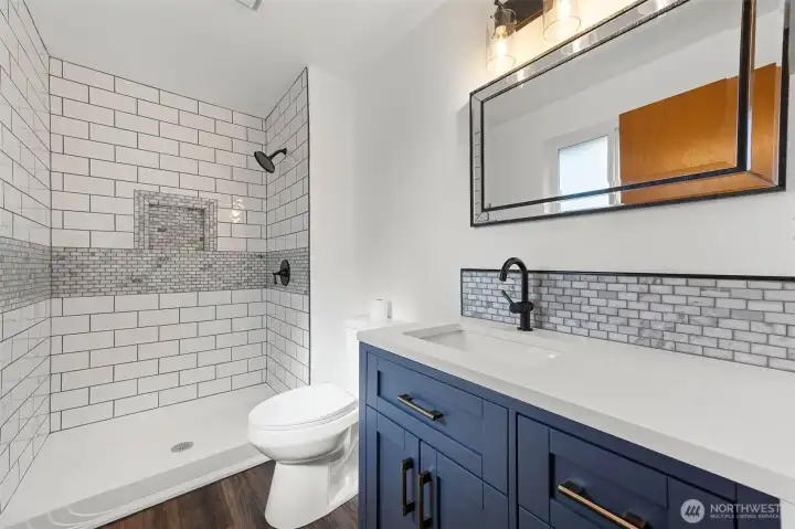 Updated beautiful primary bath with gorgeous tile work in the shower.