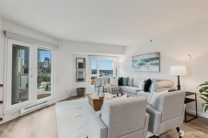 Large southwest corner condo has windows that wrap the living room and showcase the iconic Seattle views.