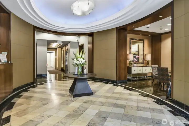 Residents enjoy full-service luxury amenities, including a 24-hour concierge, fitness center, spa/sauna, business center, guest suites, and a resident lounge.