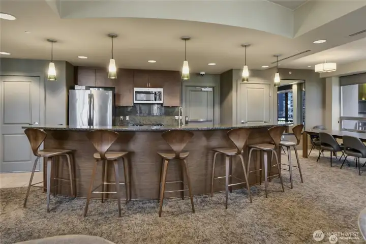 The built-in kitchen with granite counters, bar seating, and stainless-steel appliances makes entertaining easy and convenient.