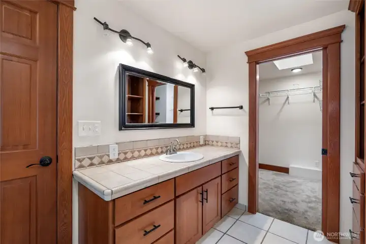 This ensuite offers a functional design with generous storage and a seamless flow