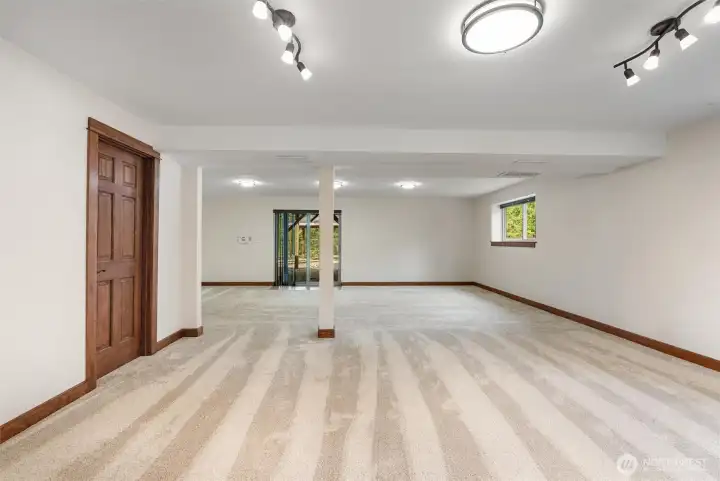 Versatile lower level ready to become your ideal living, media, or recreation space