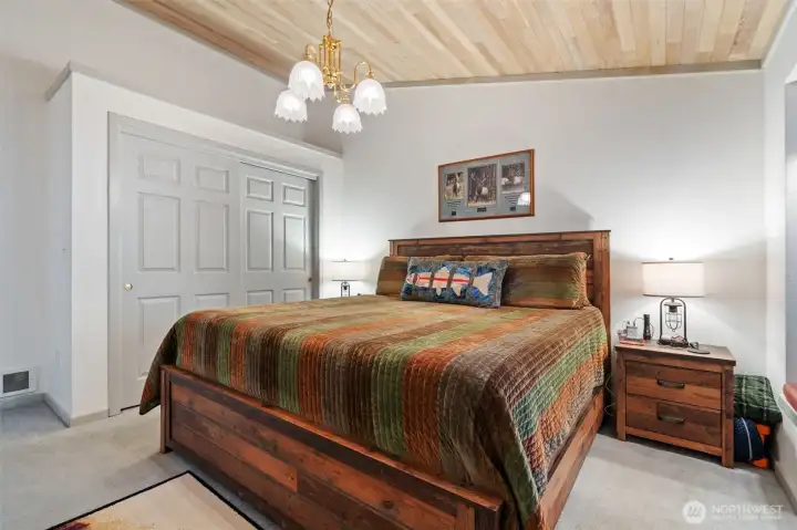 Bedroom with window seat off entry hallway.  Cedar-lined ceilings fit right in with our wooded wonderland.