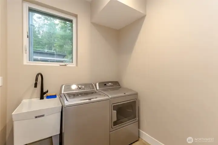 Laundry room has convenient utility sink