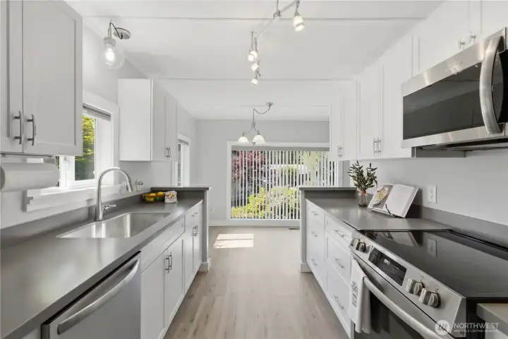 Beautifully appointed Kitchen with Corian countertops and SS appliances