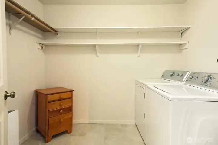 Walk in closet with washer & dryer and new (2025) water heater (adjacent to washer not in photo).