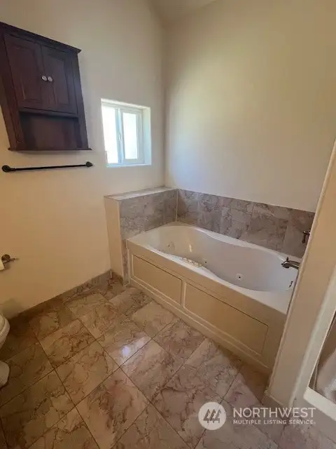 Jetted tub in the main bathroom and separate shower stall.