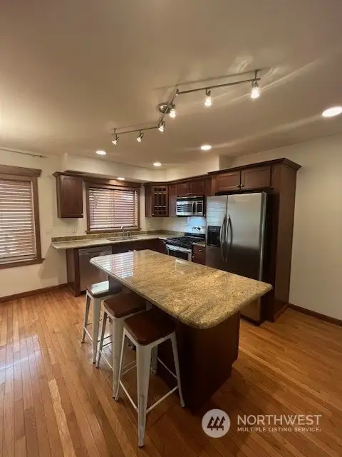 The kitchen and sitting bar is very spacious! The cabinets are a beautiful color and tops are granite! All stainless steel appliances!