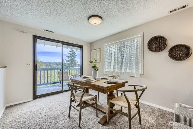 Large dining area with slider to upper deck with lake view.