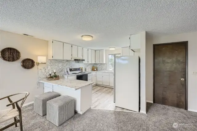 Upstairs kitchen. Refreshed in 2023 with new flooring, countertops and backsplash.