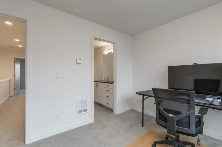 A view of the main bath from the bedroom/office