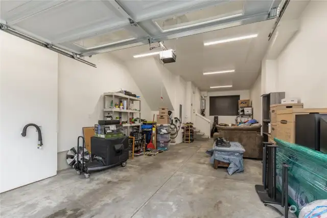 The garage is a two-car tandem set up, with storage areas and good lighting