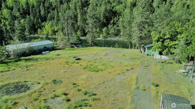 Green "casita" or tiny home has power, water, a half bath, stack W/D, and could be used as a small dwelling until building.