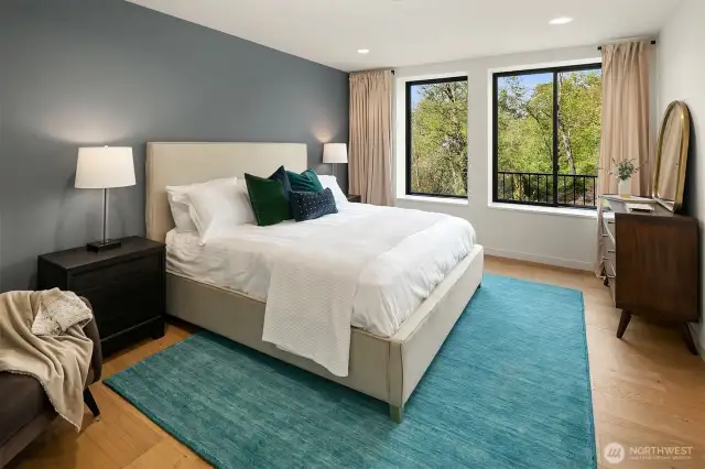 The primary bedroom offers peaceful privacy with views facing the Bellevue Botanical Garden, along with spacious walk-in closet