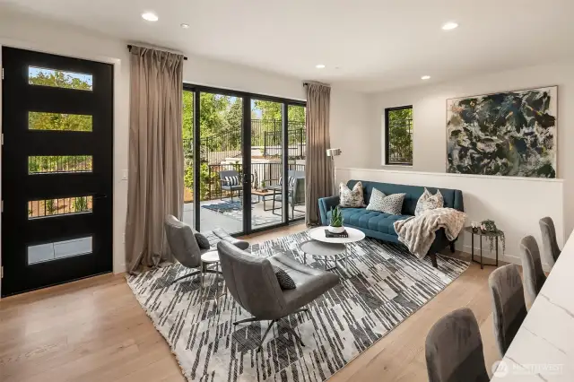 A large sliding patio door off the living room open to an outdoor living space.