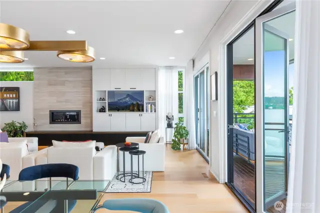 Two sets of sliding doors open from the main living area to the heated deck and Lake Washington and Cascade views.