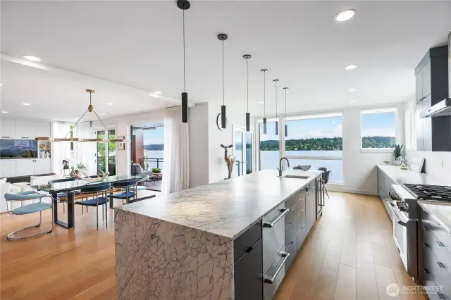 Beautifully updated kitchen with Large center island, walls of custom cabinetry, shelving and storage and mutliple prep areas.