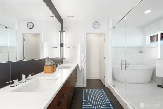 Primary bedroom suite bathroom, dual sinks, oversized shower with soaking tub.