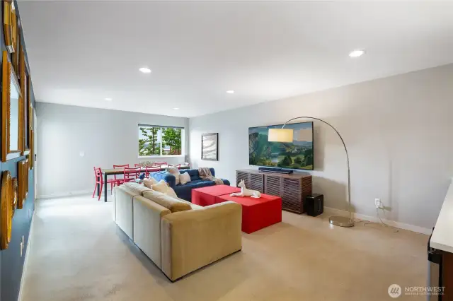 Lower floor, daylight family room with polished concrete floors, built in flat screen, storage and easy access to the outdoor dining and entertaining areas.