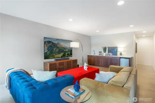 Family room with built in storage/entertaining sideboard with wet bar and beverage fridge.