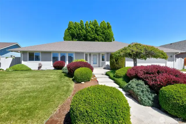 Front view of house, with meticulous landscaping