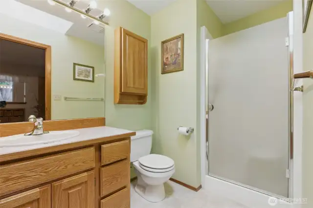 Primary bathroom is a 3/4 bath with shower and skylight