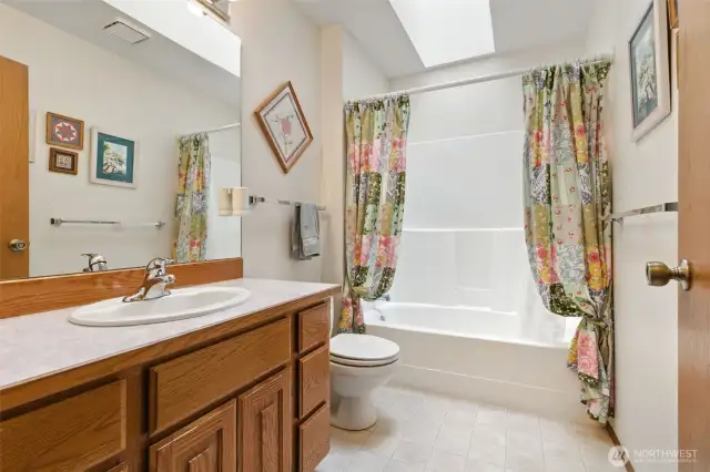 Full bathroom featuring skylight