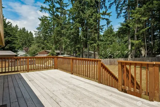 spacious deck overlooks the yard.