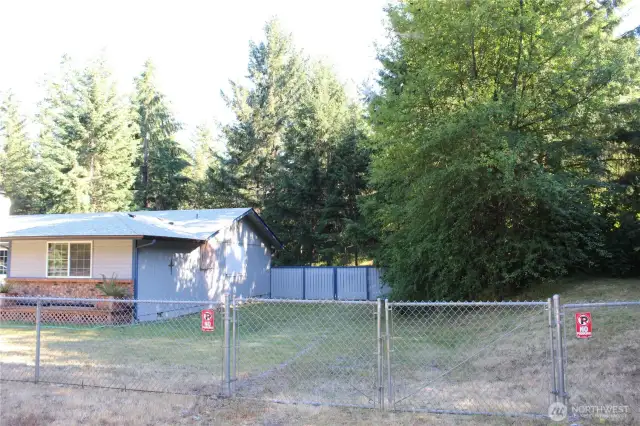 Vehicle gate on the West side of the front yard.