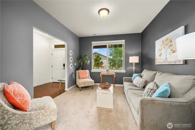View of the first living space from the formal dining room. On the left is the front entrance to the home.