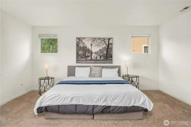 View of the primary suite from the ensuite bathroom! Currently utilizing a king size be with plenty of extra space!