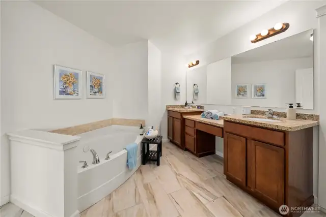 This ensuite bathroom is a dream! With a large soaking tub, a double vanity, walk-in shower, and water closet, this bathroom has it all!