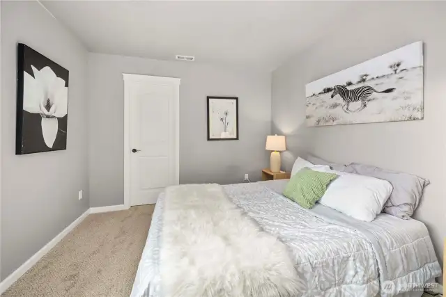 This third bedroom at the end of the hall boasts an incredible walk-in closet!
