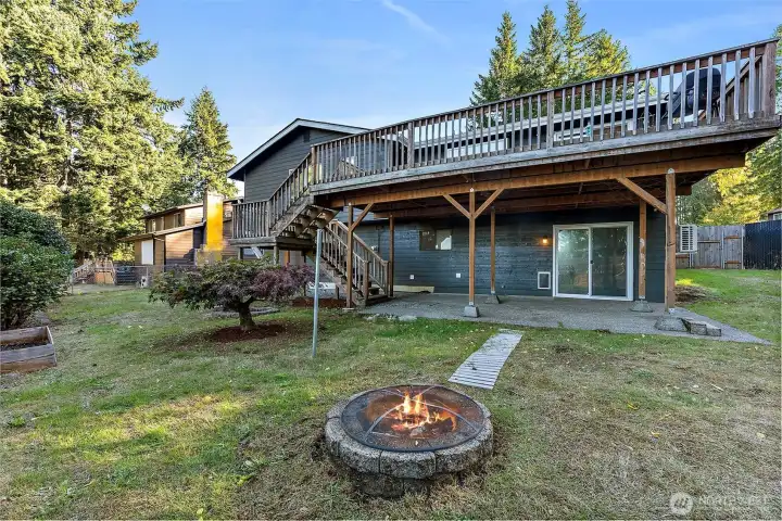 Fire pit, garden space, patio, slider from lower-level great room.