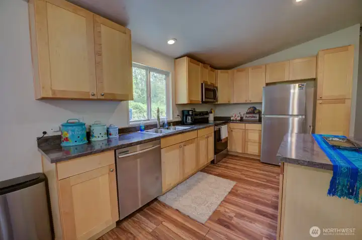 Open Kitchen with island and stainless appliances.
