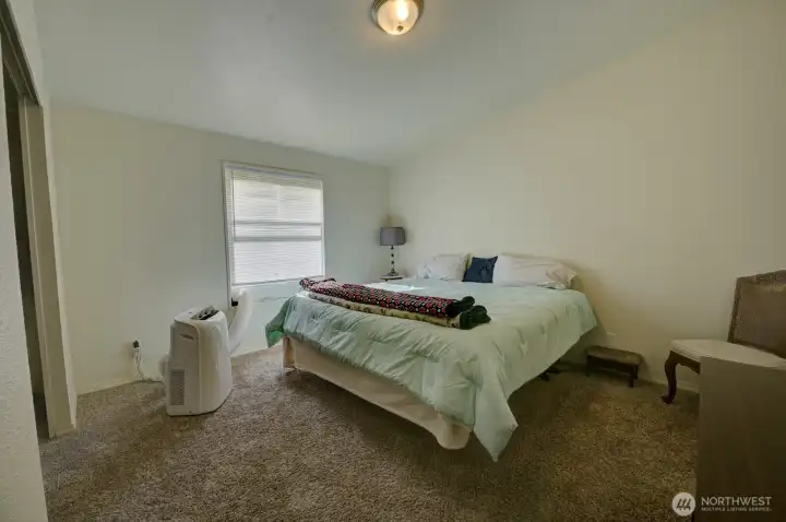 Primary bedroom with wall-to-wall carpet and en-suite bathroom and large closet.