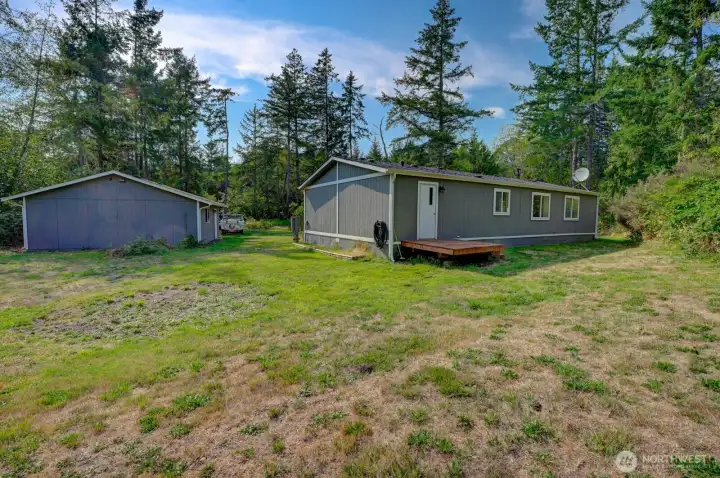 View of backyard looking toward house and shop/garage.