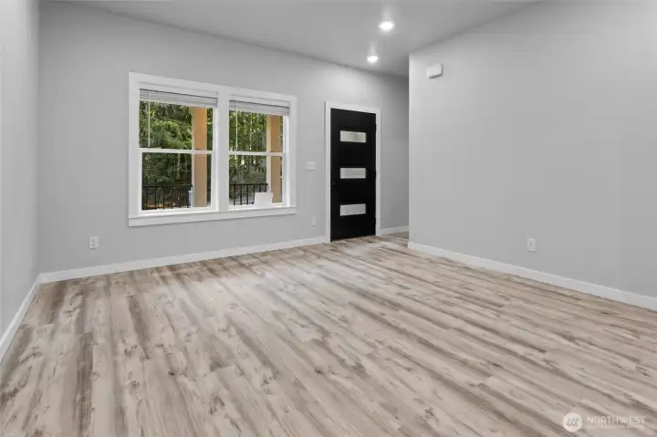 Front door entering living room. This description captures the view from the entrance, highlighting the transition from the exterior to the main living area of the property.