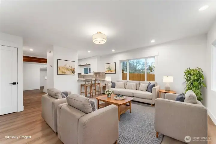 Virtually Staged - Step through the front door and experience the feel of a completely remodeled home, featuring new flooring, fresh paint, updated windows, and modern light fixtures throughout—creating a beautifully warm and welcoming space.