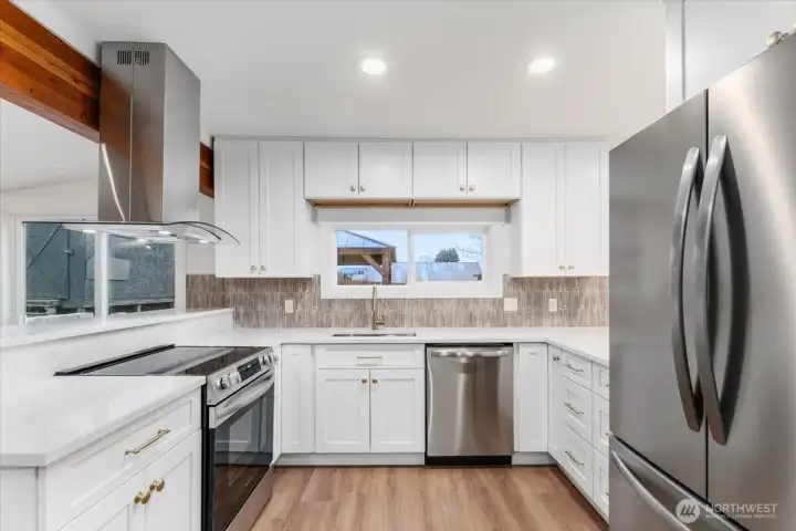 The kitchen has been completely remodeled with new stainless steel appliances, new cabinetry, updated countertops, and a stylish backsplash—bright, clean, and modern.