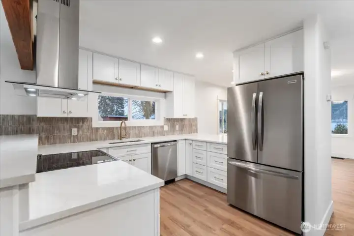 Designed to feel both defined and open, the kitchen connects seamlessly to the surrounding living spaces, creating a warm and welcoming atmosphere perfect for gathering.