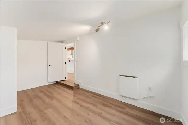 The second bedroom features the same updated finishes as the rest of the home, including modern light fixtures for a cohesive, refreshed look.
