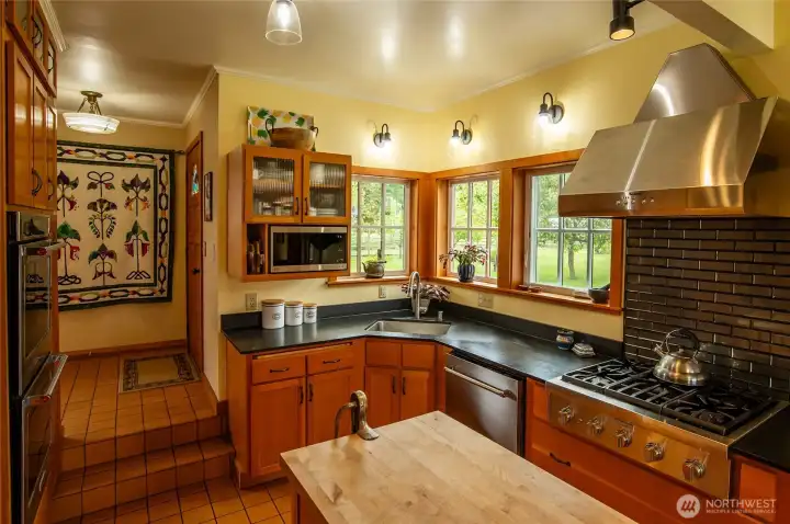 Main house floor 1 chef's kitchen with instant hot water, high end appliances, and custom vertical grain fir cabinetry